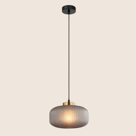 "Pendant light with soft gray glass shade and elegant gold finish, providing a modern and sophisticated touch."