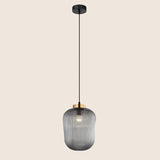 "Pendant light with striped glass shade and gold top, offering elegant illumination for modern interiors."