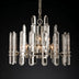 Round chandelier with clear crystal prisms and metallic finish hanging against a black background.
