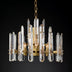 Prizma Round Chandelier with clear glass prisms and gold finish on a dark background, dimensions not visible.