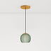 Pendant light with a spherical glass shade, green finish, suspended by a black cord from a gold ceiling mount.