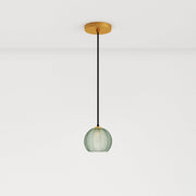 A green glass pendant light with a round shape, approximately 12 inches in height, hanging from a black cord and gold ceiling