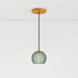 Aalin pendant light featuring a round green glass shade with a textured design, suspended from a black cord and gold ceiling 