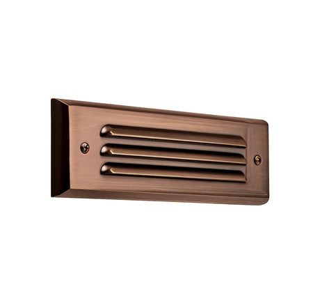 "Brass step light with horizontal grille design, made from weather-resistant brass, ideal for outdoor staircases and pathways"