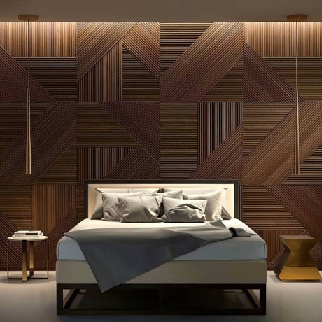 Bed with gray linens against a slatted wood wall panel in a modern room, featuring soft lighting and a side table.