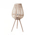 A tall, woven floor lantern with a light wood finish, featuring a unique egg shape and three slender legs.