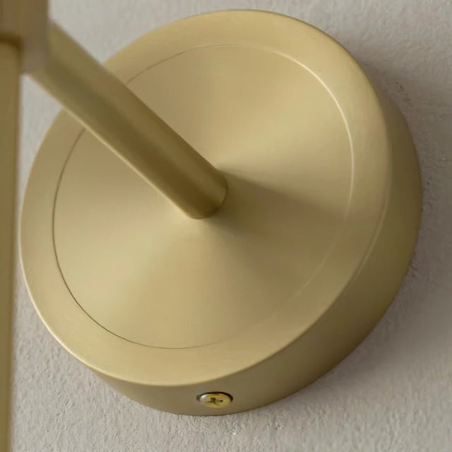"Close-up of the brass mounting detail of a modern wall lamp, showing its elegant design and construction."