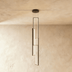 Modern pendant light with stacked rectangular neon tubes in warm gold, suspended from black ceiling canopy against dark studi
