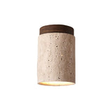 "Isolated cylindrical yellow travertine ceiling light with dark wood top, modern design."