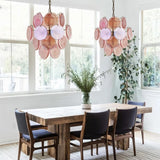 "Two Murano glass disc chandeliers in a dining room."