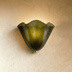White ceramic wall sconce with scalloped edges and curved arms, front view on white background.