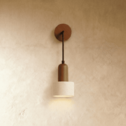 Wooden pendant light with natural finish dome shade and black metal hardware, mounted above bedside table in modern bedroom.