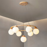 "Circular wood frame chandelier with frosted glass globes, viewed from below showing the ceiling mount and suspension cables."