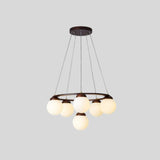 "Circular dark wood frame chandelier with seven frosted glass globes, suspended by cables, isolated on a light gray background."