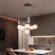 "Circular wood frame chandelier with frosted glass globes hanging above a dining table in a modern dining room."
