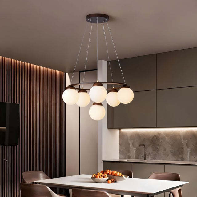 "Circular wood frame chandelier with frosted glass globes hanging above a dining table in a modern dining room."