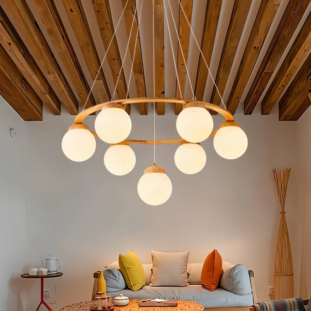 "Circular wood frame chandelier with frosted glass globes hanging above a sofa in a living room with a wooden ceiling."