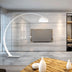 Curved white floor lamp in a modern living room, illuminating a sleek TV and wooden table, creating a cozy atmosphere.