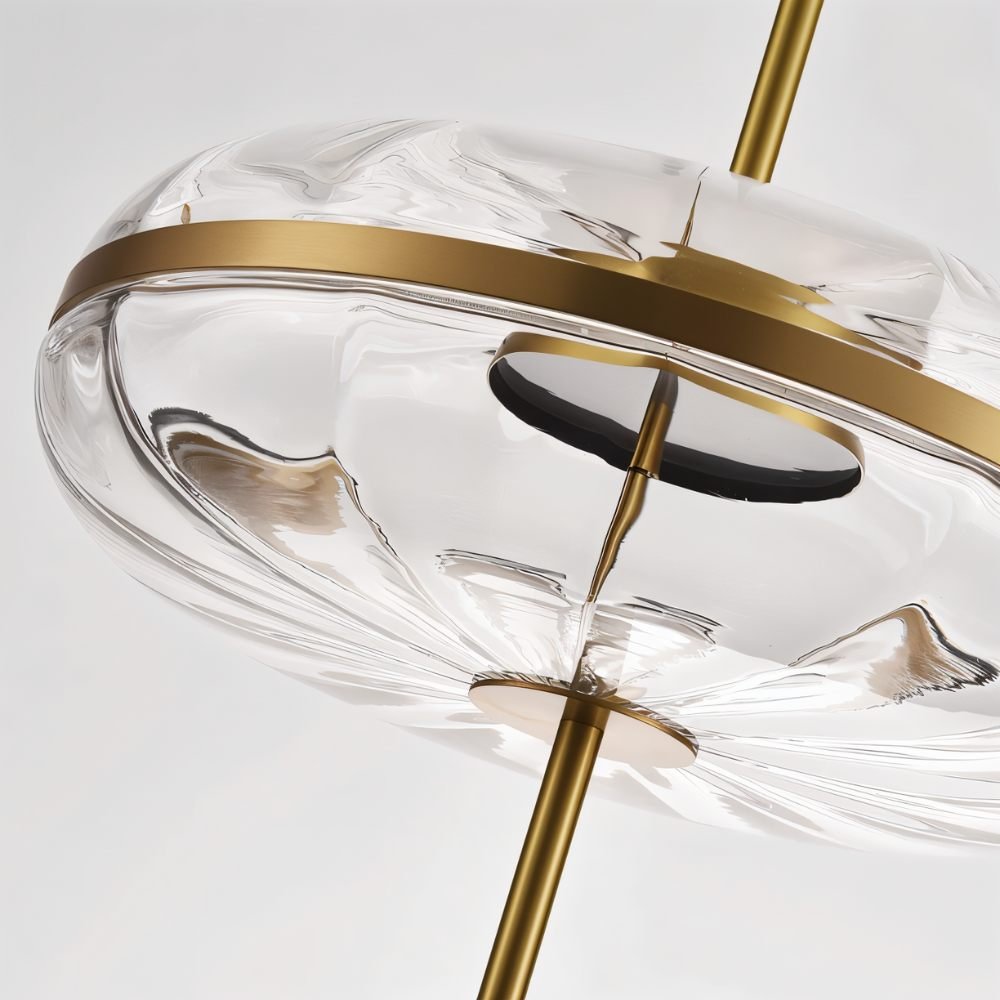 "Detailed view of the sculptural glass on a pendant light with metal frame."