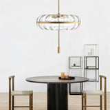 "Sculptural glass pendant light with rippled texture and metal frame, hanging above a dining table."
