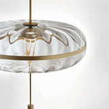 "Close-up of the textured glass on a sculptural pendant light with metal frame."