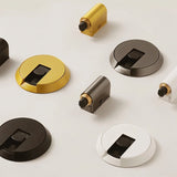 "Assortment of modern brass door stops in various shapes, sizes, and finishes."