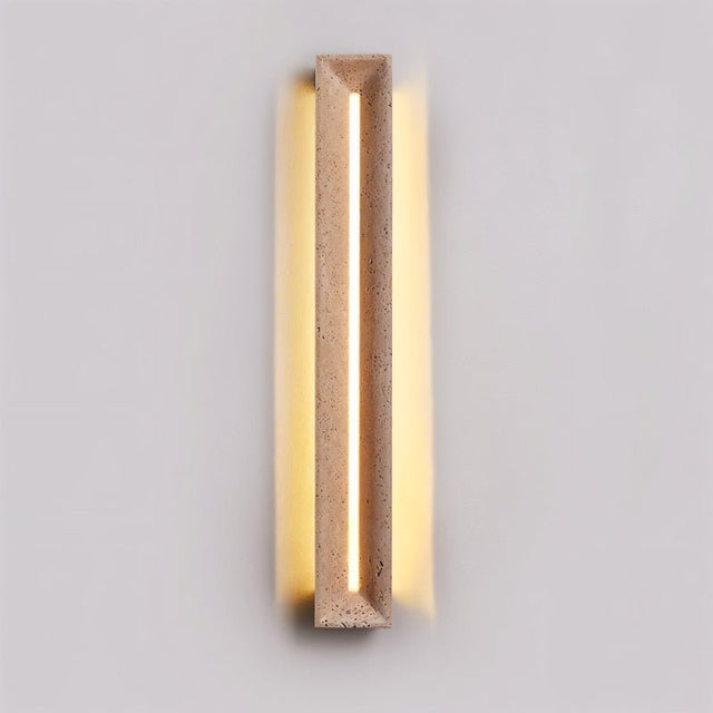 "Minimalist travertine wall lamp with a geometric frame, casting warm diffused lighting for a sophisticated ambiance."
