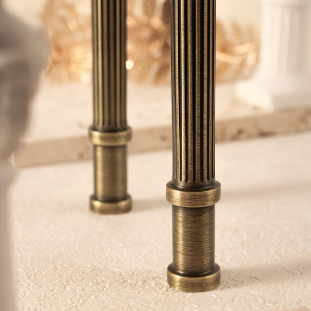 "Close-up details of antique brass fluted pull bars with detailed end caps, showcasing the ribbed texture and classical design."
