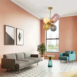  "Modern pendant light with clustered asymmetrical glass shades in a pink-themed living room."