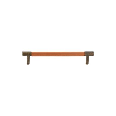 "A modern tan leather and brass cabinet pull bar on a white background."