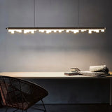 "Linear pendant light with a sleek aluminum frame and geometric acrylic diffusers illuminating a modern dining room."