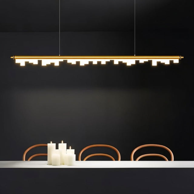 "Gold linear pendant light with geometric acrylic diffusers creating a warm ambiance in a modern dining room."