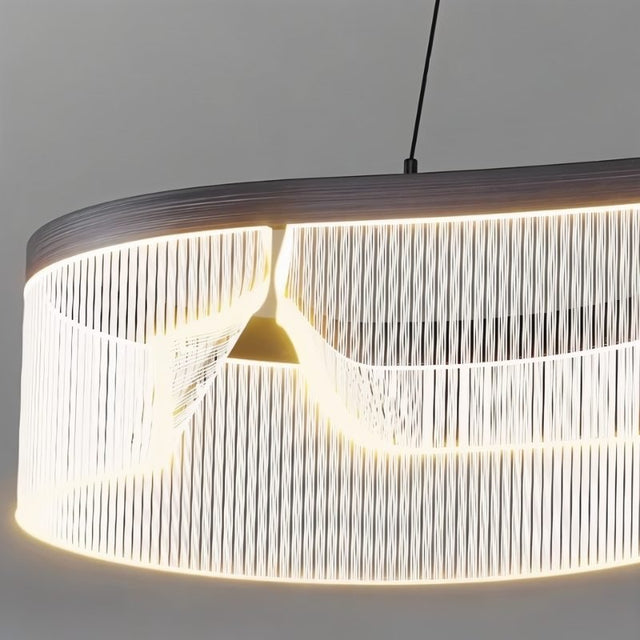 "Close-up of a modern chandelier featuring an undulating acrylic shade and sleek iron frame, showcasing its unique design."
