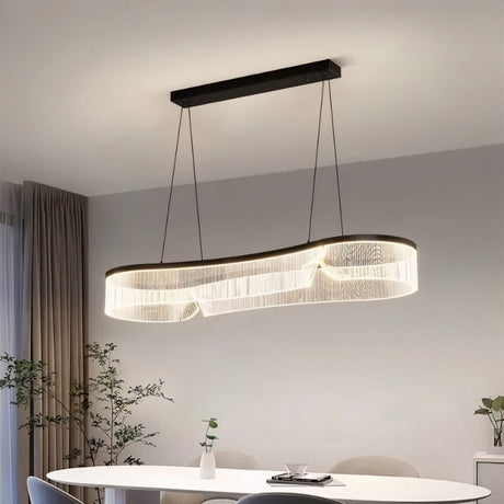 "Elongated chandelier with a sleek iron frame and undulating acrylic shade hangs above a modern dining table, providing even lighting."