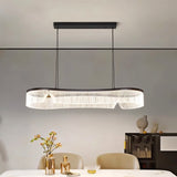 "Modern chandelier with a sleek iron frame and undulating acrylic shade illuminating a contemporary dining room."