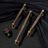 "Brass antique twisted fluted knobs and pulls on a dark background"