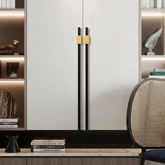 "Black and gold aluminum pull bars on a modern white wardrobe with open shelving."