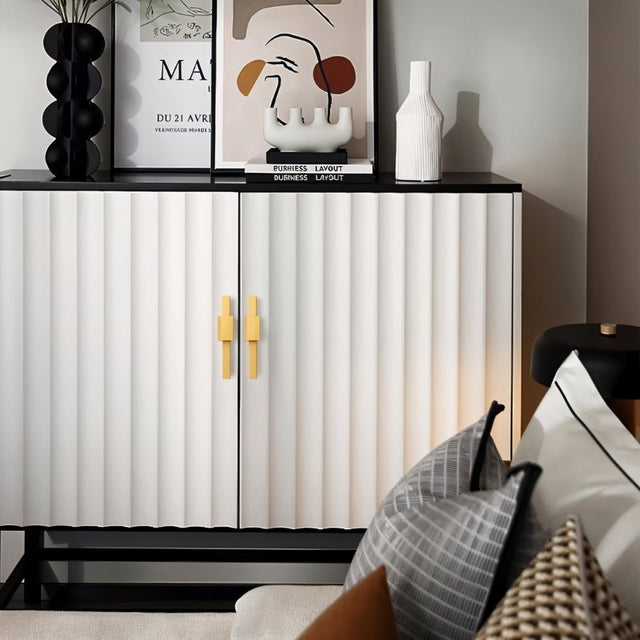 "Gold aluminum pull bars on a modern white cabinet with fluted design."