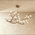 Gold branch-style chandelier with eight frosted glass globes hanging from ceiling against white background.