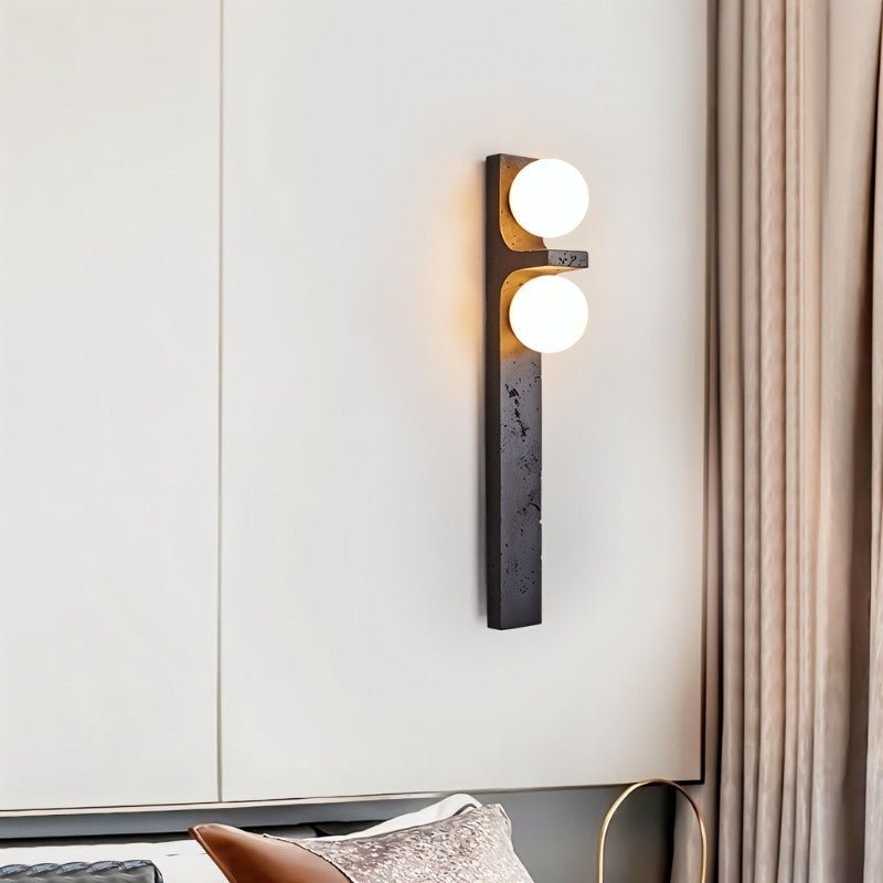 "Modern wall lighting fixture with two frosted glass globes mounted on a vertical travertine base."
