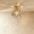 Gold petal-shaped ceiling light fixture mounted on white ceiling in modern bathroom interior