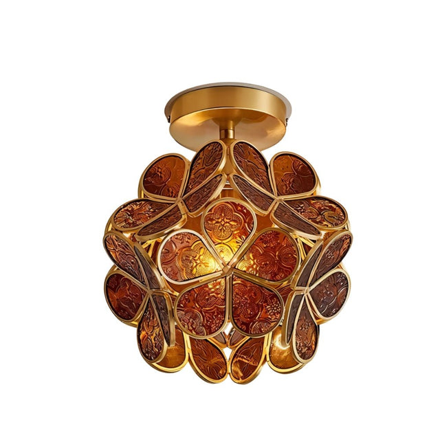 "A warm amber ceiling light with a brass frame and intricately patterned glass petals, creating a rich and inviting ambiance."