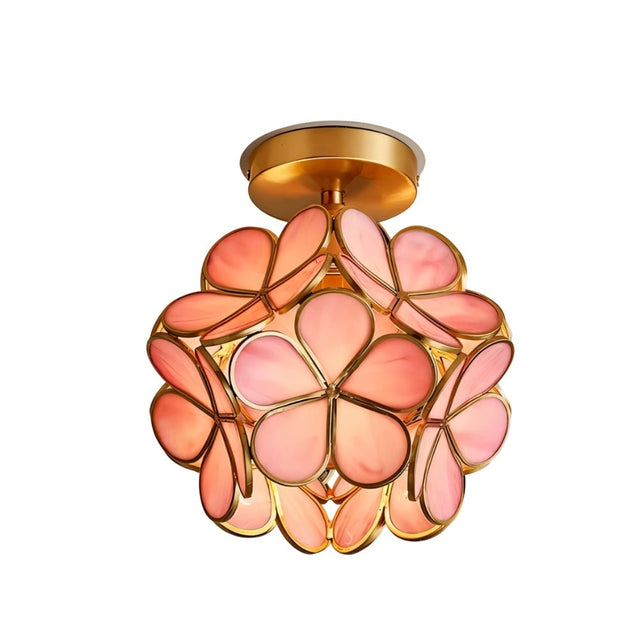 "A pink floral ceiling light with a brass frame and delicate glass petals, creating a warm and elegant ambiance."