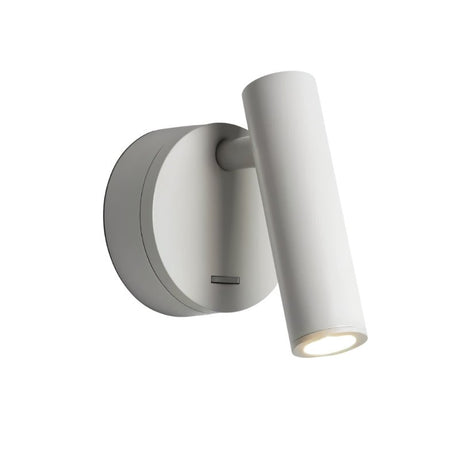 "A white aluminum wall lamp with an adjustable cylindrical head, shown lit up against a white background."