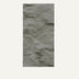Textured concrete wall panel in light gray with rough, uneven surface finish.