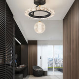 "A black ceiling light with a circular frame and a hanging crystal sphere, installed in a hallway with a dark wall panel and a view of a city."