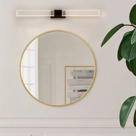 "Modern bathroom vanity light with gold accents and a linear design above a round mirror."