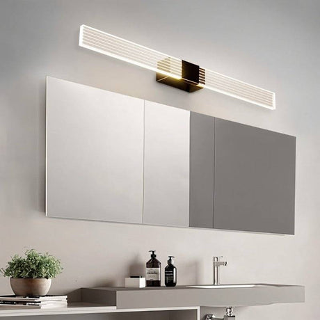 "Long, modern bathroom vanity light with a minimalist design above a large mirror."