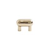 "Sleek, capsule-shaped brass knob with a polished finish, suitable for modern or minimalist interiors."
