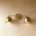Three-light vanity fixture with dome shades in matte black finish on white background, front view showing dimensions.